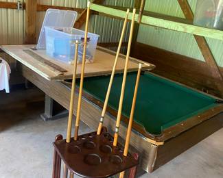 Garage tool table with a cover to convert to a ping pong table, cues are separate price. Balls, net, etc are separate.