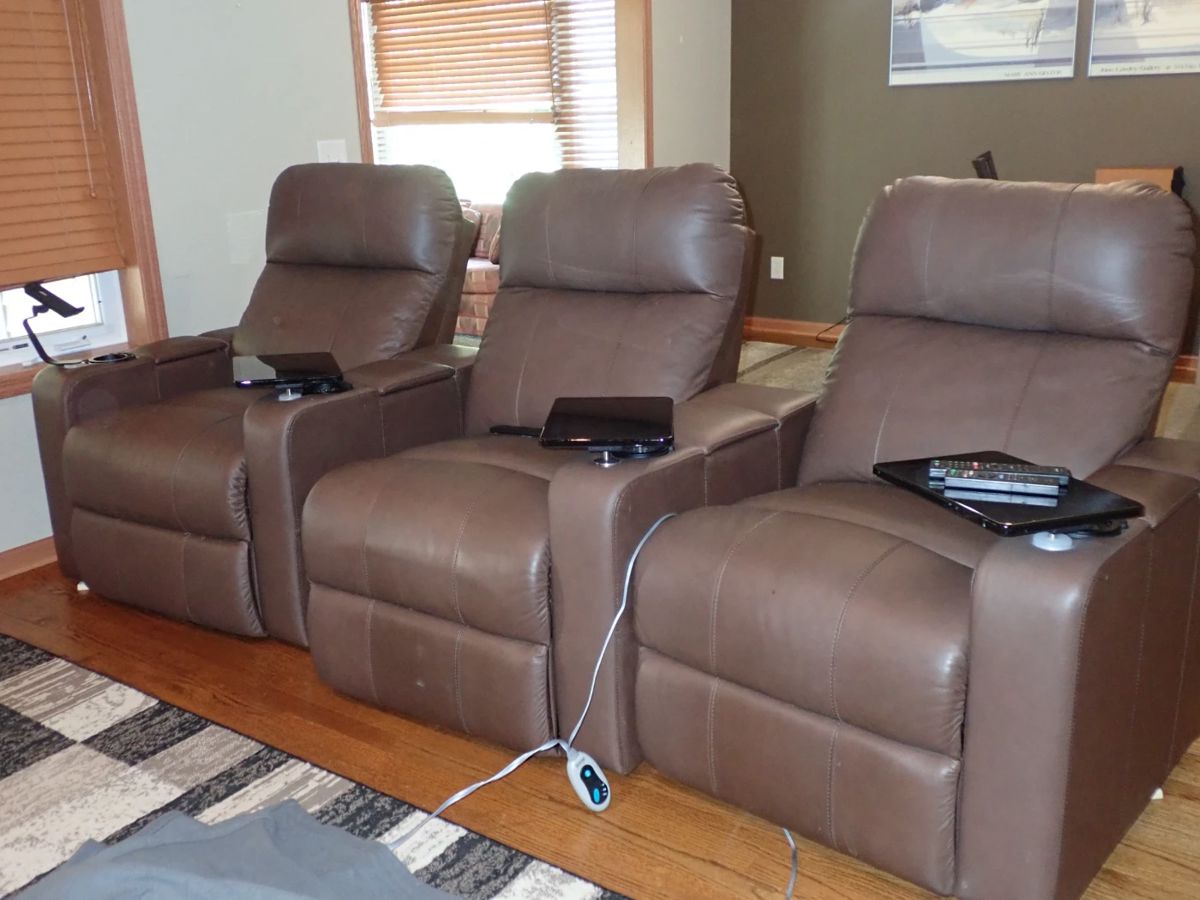 Theatre seating with electric reclining, cup holder & tray. 