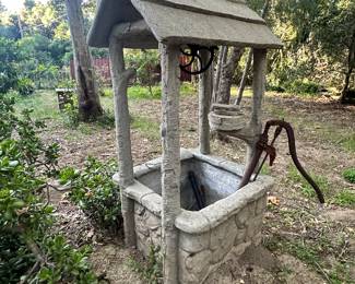 Antique concrete wishing well 