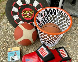 Dart board. Basketball net garbage can. Boxing gloves.
