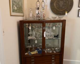 Apothecary cabinet filled with sterling, crystal, and porcelain.