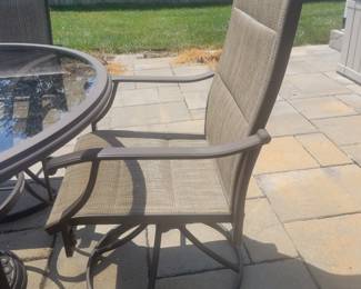 QUALITY GREAT CONDITION HAMPTON BAY ROUND GLASS TOP PATIO TABLE WITH FOUR ARMMED SWIVEL CHAIRS $150......UMBRELLA AND BASE PRICED SEPARATELY @$50- TOTAL $200 FOR PATIO SET WITH UMBRELLA AND BASE