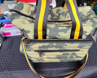 Woman's Handbags THINK ROYLN - The Highlander Duffel Bag w/ Trolly Sleeve- this bag is loaded with pockets and plenty of storage done in camo military green and bright orange/black accents. Description
Travel plans? If not, you'll definitely want to make them once you get your hands on this fab bag. With a convenient trolley sleeve and plenty of exterior pockets (and interior space!) this duffel bag keeps you organized (and looking so cute paired with your airport athleisure 'fit!). From Think Royln.
Style: The Highlander
Reversible strap, trolley sleeve, top zip entry, four zip pockets
Lined interior, zip pocket
Measures approximately 16" x 12.75" with a 52" strap; weighs 2.17 lbs
Shell 100% nylon; lining 100% polyesterOUR PRICE $40.00(list $99-$258 on ebay)