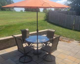 QUALITY GREAT CONDITION HAMPTON BAY ROUND GLASS TOP PATIO TABLE WITH FOUR ARMMED SWIVEL CHAIRS $150......UMBRELLA AND BASE PRICED SEPARATELY @$50- TOTAL $200 FOR PATIO SET WITH UMBRELLA AND BASE