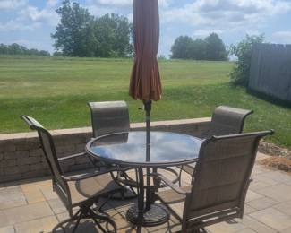 QUALITY GREAT CONDITION HAMPTON BAY ROUND GLASS TOP PATIO TABLE WITH FOUR ARMMED SWIVEL CHAIRS $150......UMBRELLA AND BASE PRICED SEPARATELY @$50- TOTAL $200 FOR PATIO SET WITH UMBRELLA AND BASE