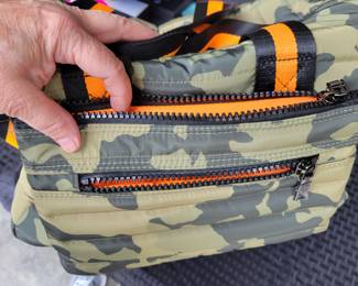 Woman's Handbags THINK ROYLN - The Highlander Duffel Bag w/ Trolly Sleeve- this bag is loaded with pockets and plenty of storage done in camo military green and bright orange/black accents. Description
Travel plans? If not, you'll definitely want to make them once you get your hands on this fab bag. With a convenient trolley sleeve and plenty of exterior pockets (and interior space!) this duffel bag keeps you organized (and looking so cute paired with your airport athleisure 'fit!). From Think Royln.
Style: The Highlander
Reversible strap, trolley sleeve, top zip entry, four zip pockets
Lined interior, zip pocket
Measures approximately 16" x 12.75" with a 52" strap; weighs 2.17 lbs
Shell 100% nylon; lining 100% polyesterOUR PRICE $40.00(list $99-$258 on ebay)