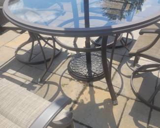 QUALITY GREAT CONDITION HAMPTON BAY ROUND GLASS TOP PATIO TABLE WITH FOUR ARMMED SWIVEL CHAIRS $150......UMBRELLA AND BASE PRICED SEPARATELY @$50- TOTAL $200 FOR PATIO SET WITH UMBRELLA AND BASE