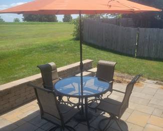 QUALITY GREAT CONDITION HAMPTON BAY ROUND GLASS TOP PATIO TABLE WITH FOUR ARMMED SWIVEL CHAIRS $150......UMBRELLA AND BASE PRICED SEPARATELY @$50- TOTAL $200 FOR PATIO SET WITH UMBRELLA AND BASE