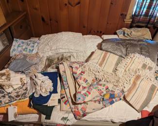 Various vintage linens including a gray satin deco throw, a Bates George Washington bedspread, white cutter chenilles, wedding band quilt, mid century drapes, pebble fabric, etc