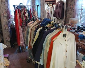 Bedroom #2 full of women's clothing  