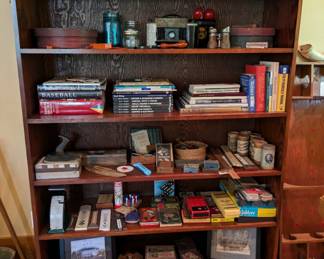 Bookshelf full of vintage and antique doo-dads and thingamajigs