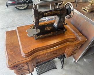 Antique sewing machine in refinished cabinet $200 or best offer.