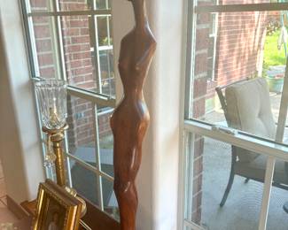 Tall signed wood sculpture on marble base