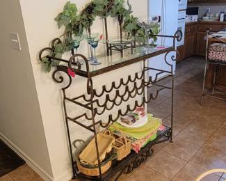 This Iron and Glass Wine rack holds 14 bottles and lots of other beautiful items. 