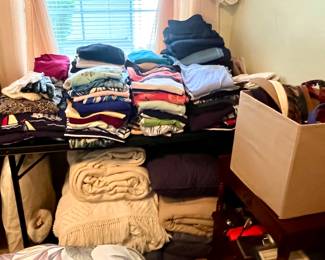 Sweaters, shirts, and blankets underneath