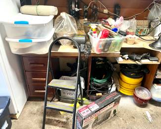 In this picture, you’ll see a shop vac, stepladder, extension cords, Cleaners, wrapping ribbon, and more