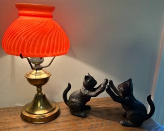 Red glass and brass lamp with cast iron cat bookends