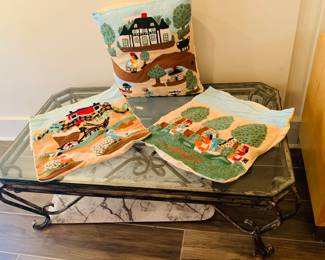 Clementine Hunter pillows and one of two glass top wrought iron low tables available