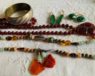 Beautiful jewelry including carved red jade. 