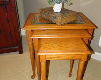The larger nesting table has a glass top