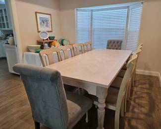 Wonderful farm table with 8 side chairs and two host chairs that are upholstered and button back. 