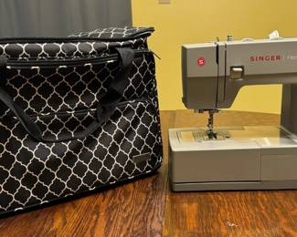 Singer sewing machine and carrying case. Upstairs please ask for assistance.