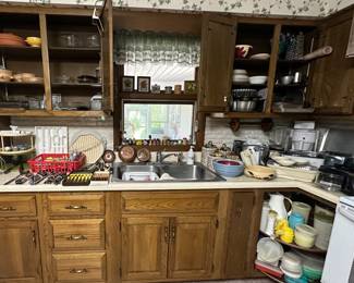 Fire King peach; Glass Bakeware; Flatware; Knives; Steak Knives; Lazy Susan’s; Copper Molds; S&P Shakers; Spice Shakers; Metal Bakeware; Canister Set; Tupperware; Storage Containers; Stoneware Nesting Bowls; Bunn Coffee Maker; Hand Mixer; Avocado Green Blender; Indoor Grill; Slow Cooker; Sunbeam Mixmaster Stand Mixer; Waffle Iron Grill; Toaster