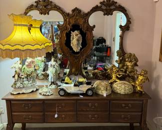 Victorian style double mirror With vintage toys and cherub statues. 