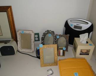 Picture frames and bathroom scale, a tissue box too
