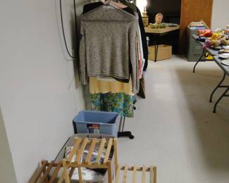 Plant stand, a large bucket of fabric pieces, a bin, and lots of clothing too