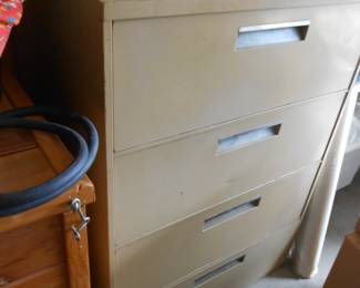 Four Drawer Metal Cabinet full of fabric material 