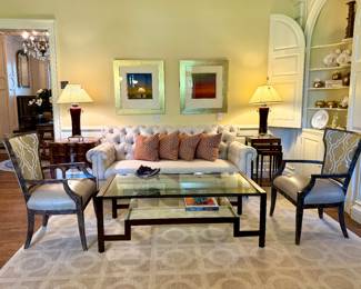 On left: SOLD 2 drawer chest by john Richards with inlaid top (similar online for $2800 ) - 26x18x28; SOLD- lamps; SOLD - pillows; Tufted Back Sofa - SOLD - 82x40x39 ; Modern geometric coffee table with textured bronze metal - $800- 56x28x19; SOLD Woodbridge nesting tables (set of 3) Dark color wood - 16.5x12.5x28.5 (for the tallest table ); SOLD Signed giclee print by Bulter of “Open Field II “(green sky) - 30x32; SOLD Signed giclee print by Bulter of “Open Field III “(dark blue sky) - 30x32; SOLD Side chair with leather seat and upholstered back by Our House Designs (2 available) - 25.5x22x37