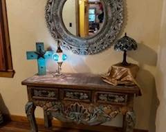 Vanity or entry table with three drawers and mirror.  Two stained glass lamps, rustic wooden cross