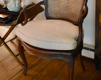 One of a pair of caned open armchairs