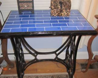 Blue tile top on wrought iron base.