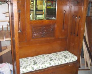 Antique oak Church Hall Tree with 8 hooks and the seat opens for storage.