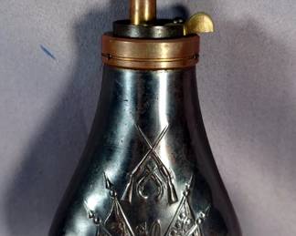 Reproduction Metal Powder Flask With Embossed Image Of Cannon, Flags, And Crossed Guns