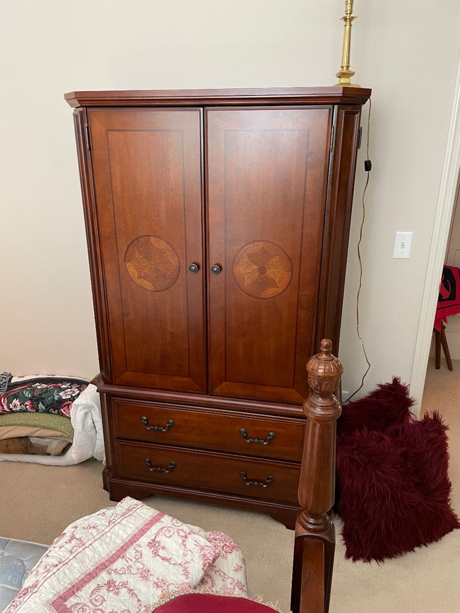 Bedroom set large armoire with inlaid wood design.