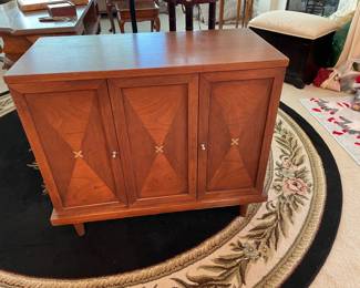 Mid century teak cabinet with one shelf.  Neat brass inlay Xs