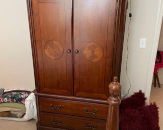 Bedroom set large armoire with inlaid wood design.