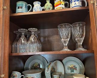 Set of dishes by Villeroy & Boch on bottom shelf. 