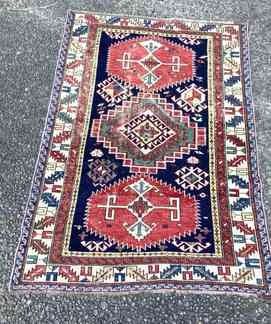 TOSH353 Handwoven Rug #5	Possibly antique and from Caucasus. Rug is approximately 57" long x 42" wide.&nbsp;There are several places where the thread is worn and a few spots where the fringe is missing.
