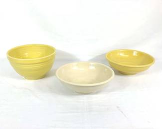 DILA704 Fiestaware Mixing Serving Bowls Set of three yellow fiesta-ware mixing and serving bowls. Smaller serving bowls measure approximately 10" diameter by 3.5" tall, larger mixing bowl measures approximately 9.5" diameter by 5" tall.