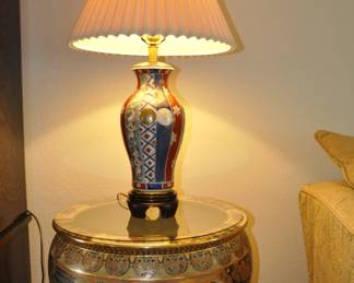 Asian themed lamp on top of fish pot with stand