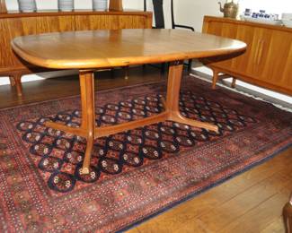 Mid Century Danish Dyrlund dining table.  42" wide x 64" long with two 20" leaves