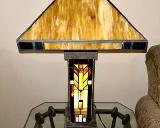Modern stained glass lamp shown with base lite up