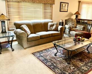 Living room furniture: Sofa, side chair w/ ottoman, matching iron with glass tops side tables and coffee table, area rug, modern stained glass table lamps