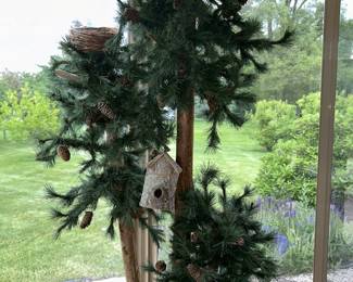 Closer view of large 3-tree on stand with decorative birdhouse/nest
