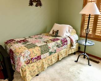 Twin size bed, iron floor lamp combined with table