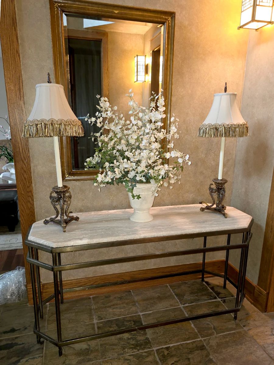 Mable top Entry Table. Base is a heavy metal. Frederik Cooper lamps. Beveled Wall Mirror with Leather Frame.